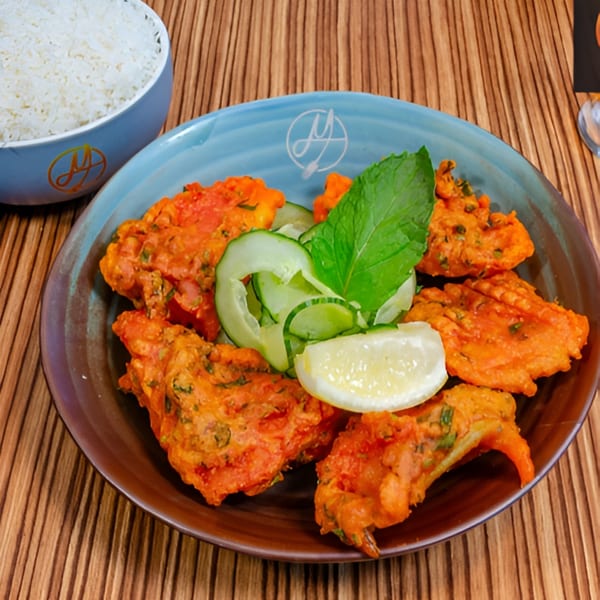 Mausam Indian Flavors' Indian pakoras with cucumber, mint, and lemon, served with a side of rice.
